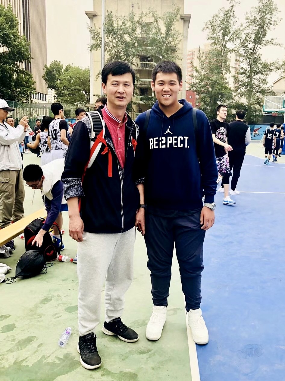 Adam Zhang courtside with the coach who would later recruit him