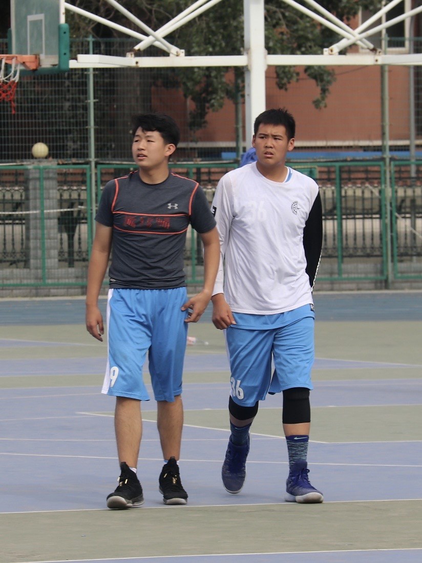 Adam Zhang warming up with a teammate before the regional league final