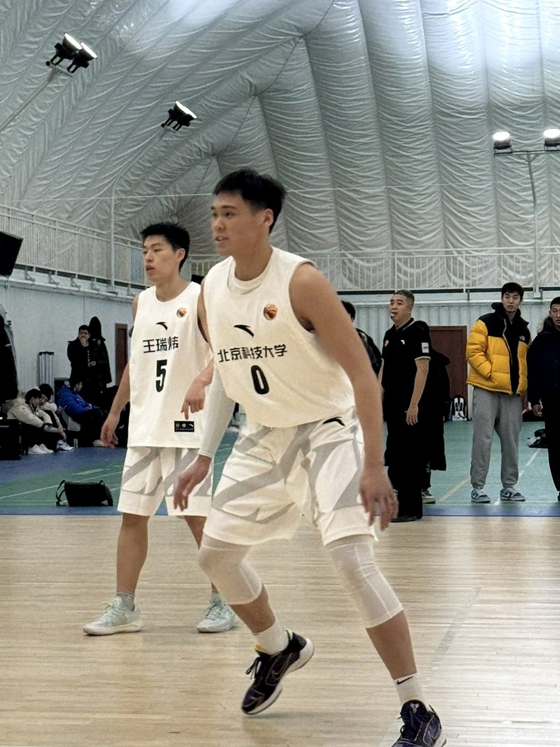 Adam Zhang, number 0, in a defensive stance for USTB in a CUBAL Beijing game