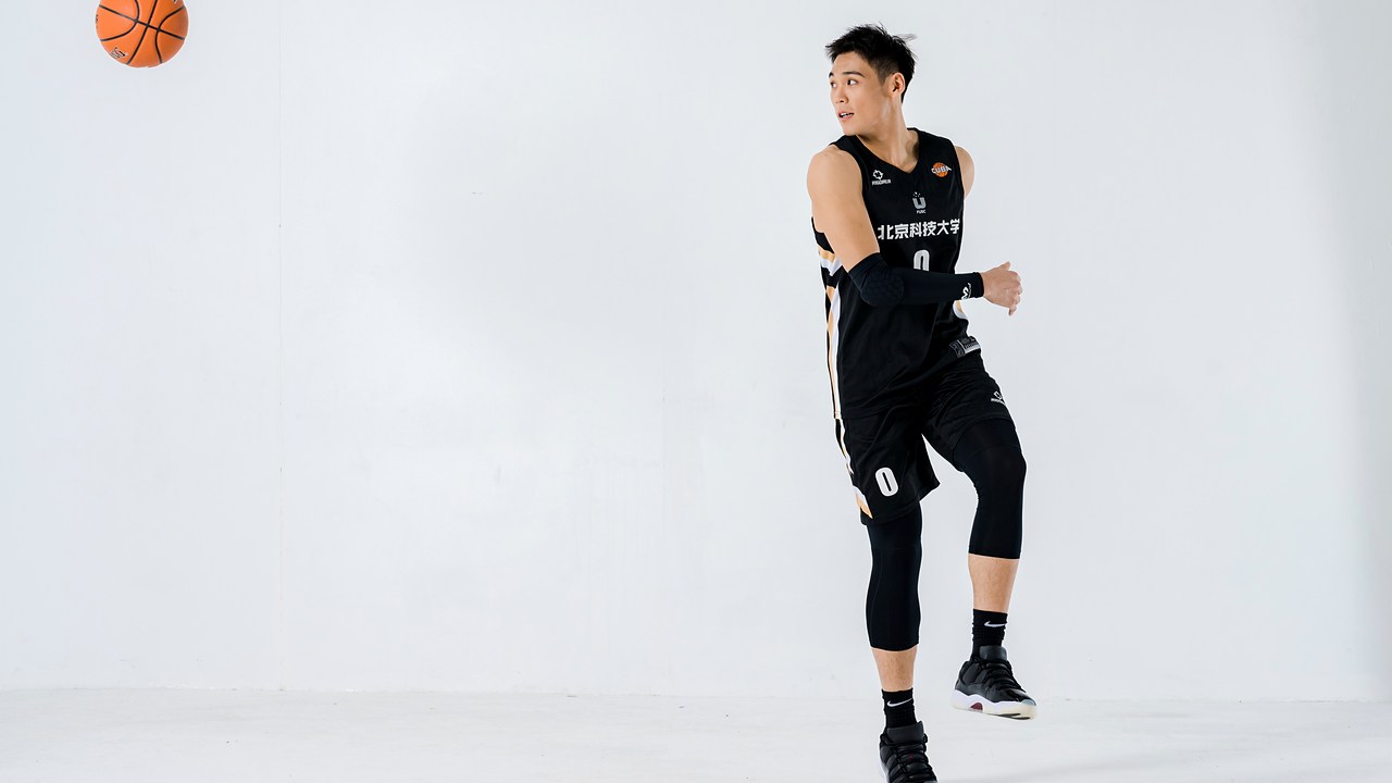 Adam Zhang in the USTB team kit in a studio portrait, number 0
