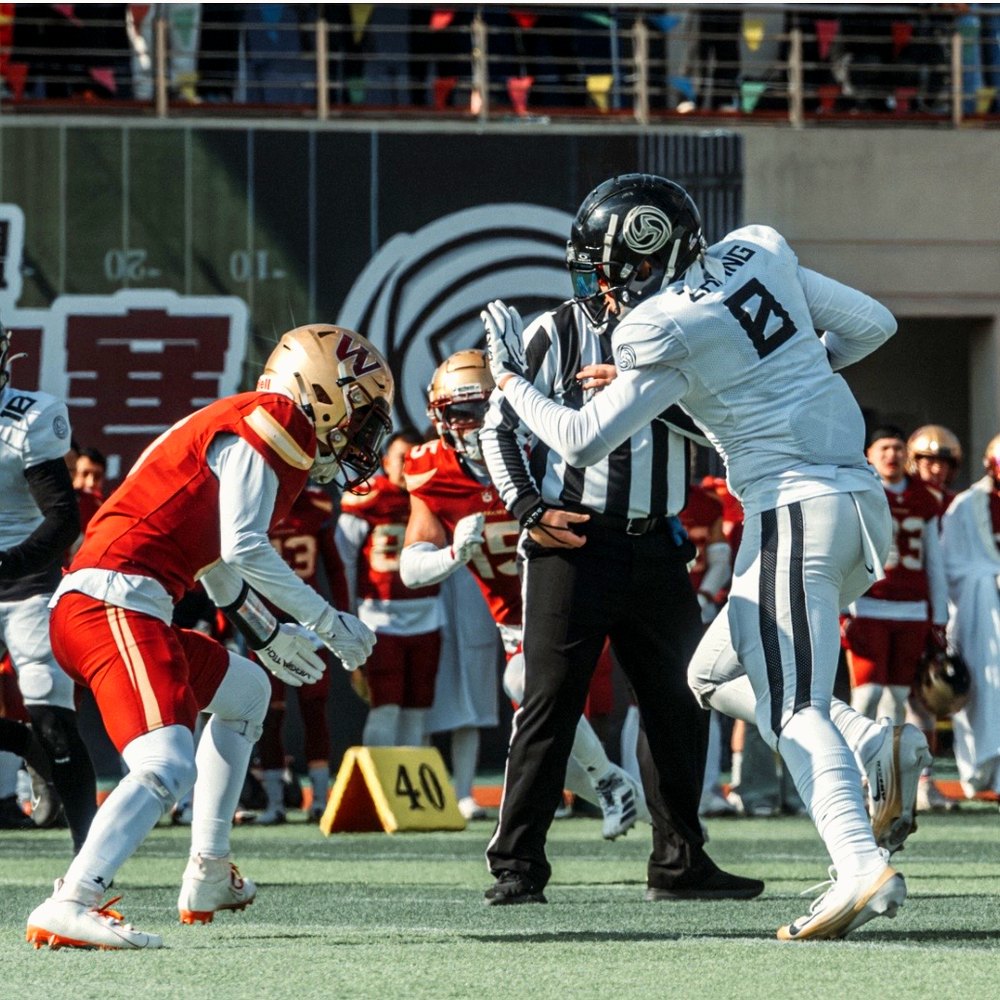 Adam Zhang, number 8, releasing off the line against a defensive back