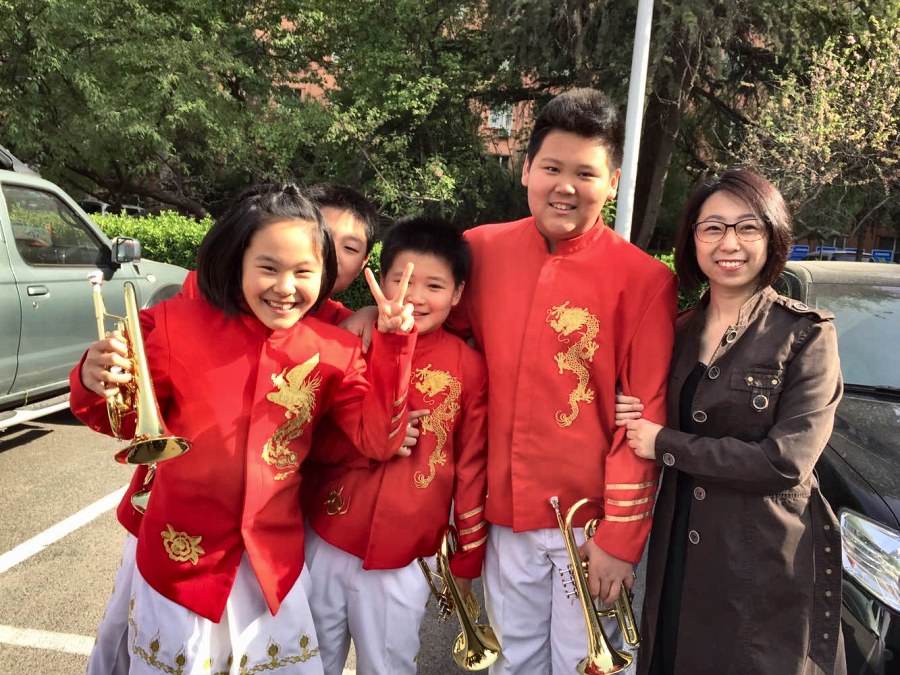 Adam Zhang with the trumpet section and their conductor after the graduation concert