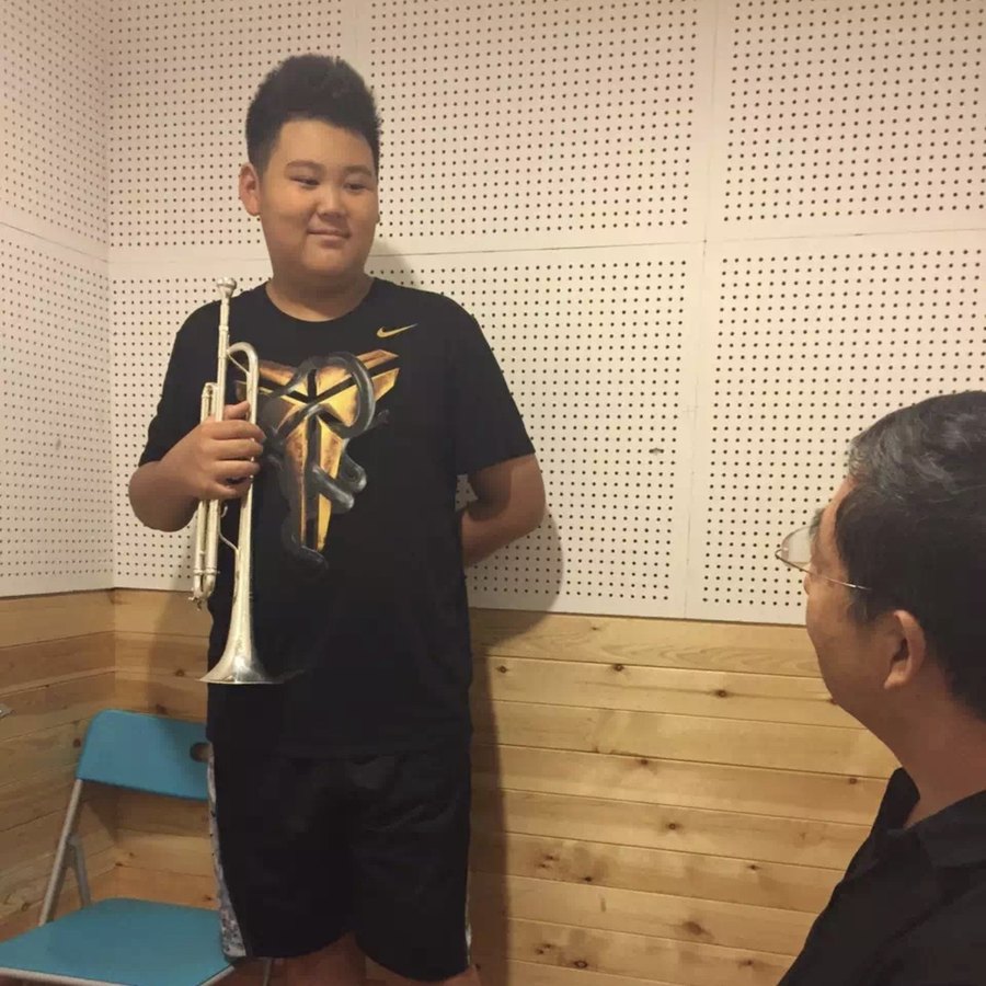 Adam Zhang with his trumpet teacher and conductor