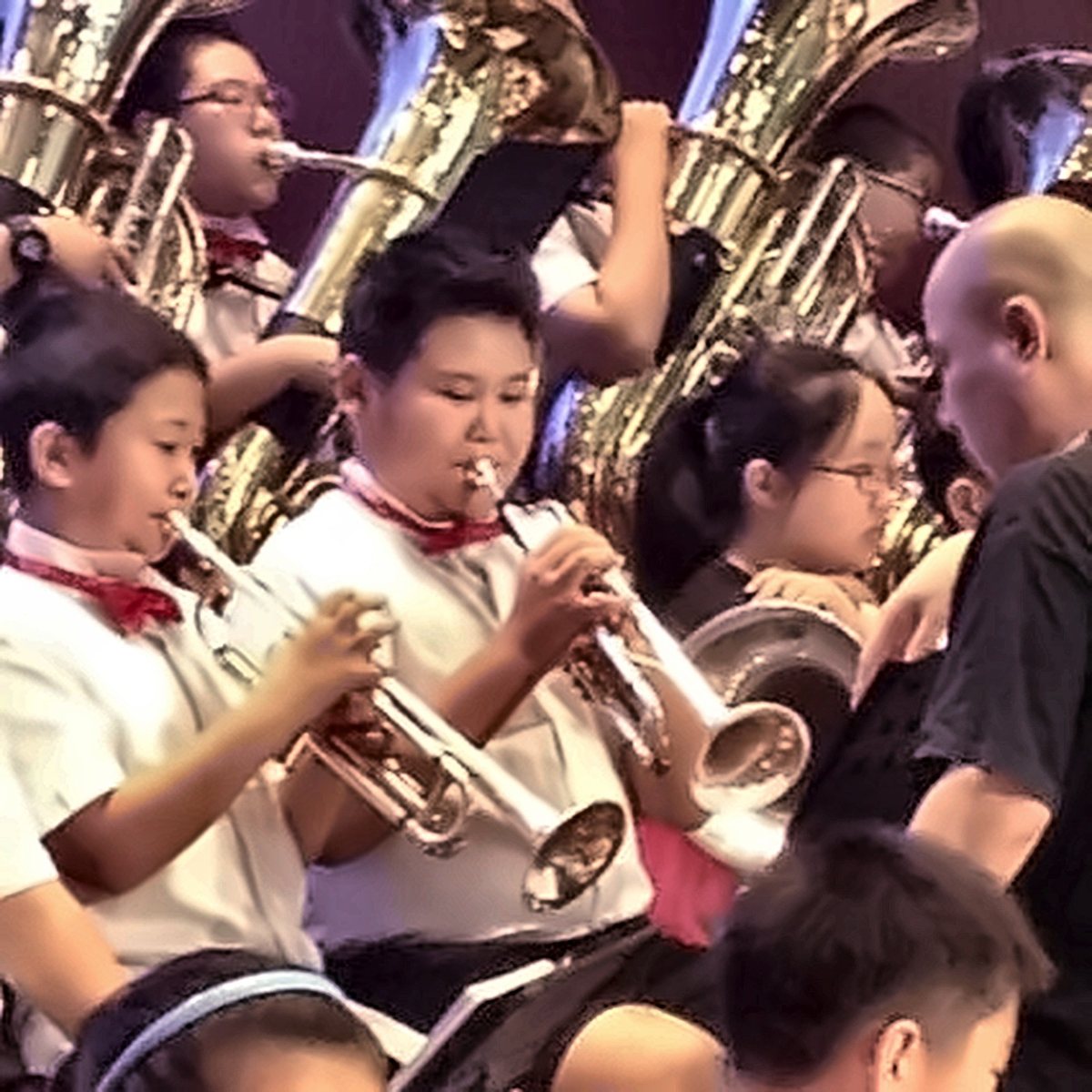 Adam Zhang playing trumpet in his school wind band as a boy